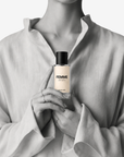 Woman holding Femme evening eau de parfum 50ml bottle by Adam Pare