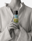 Woman holding Meadow floral eau de parfum 50ml bottle by Adam Pare