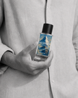 Man holding Succession woody eau de parfum 50ml bottle by Adam Pare